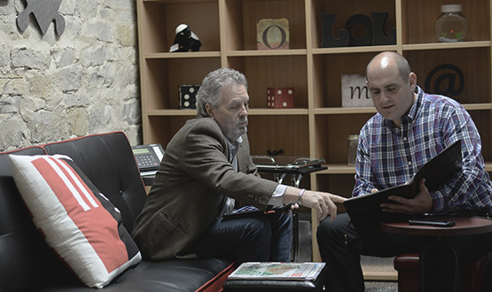 two men meeting two men going over an important document