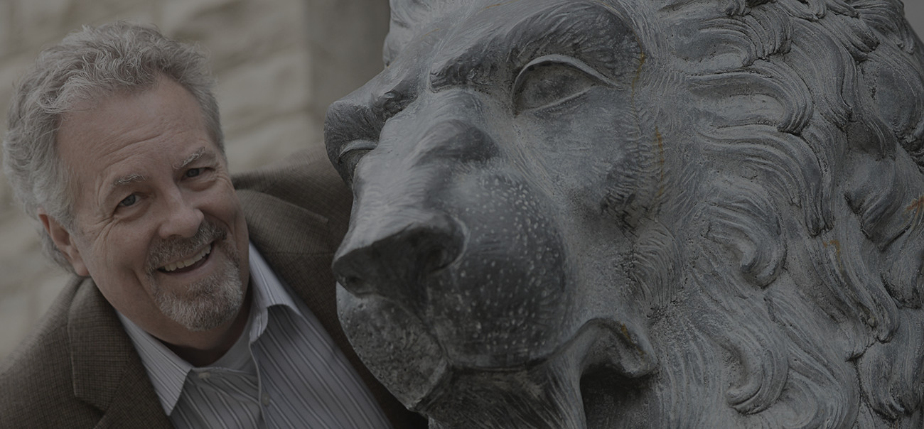 Tom Snyder by the lion statue outside of Trivera at the main mill building