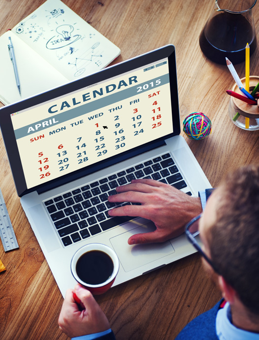 Man at computer with calendar on the screen