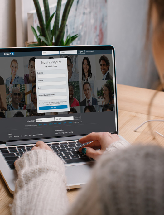 Woman on laptop looking at LinkedIn