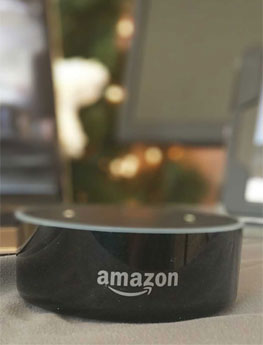 Amazon Alexa in front of laptops