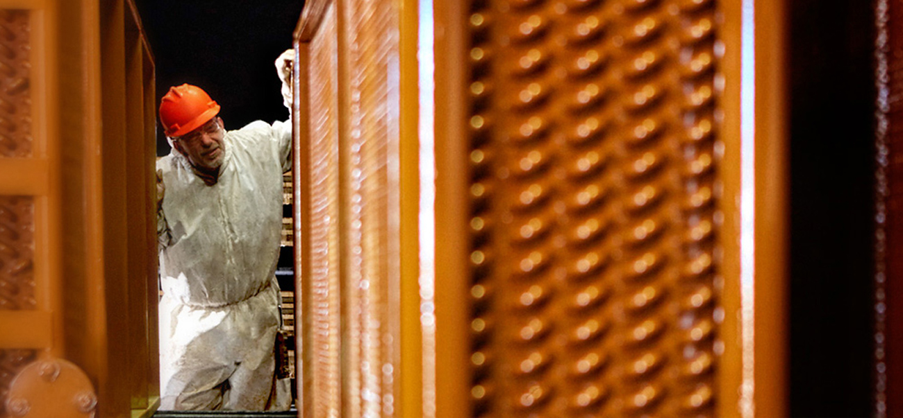 Heresite employee inspecting HVAC coating Heresite employee inspecting HVAC coating