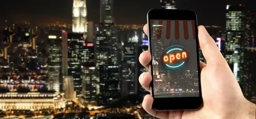 hand holding phone with open sign on it