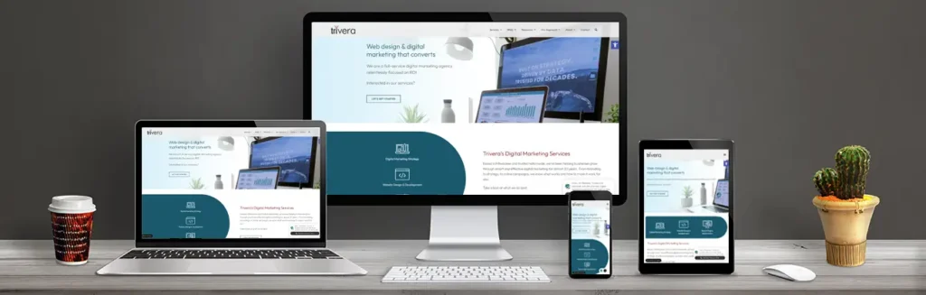 laptop, desktop, phone and tablet on desk