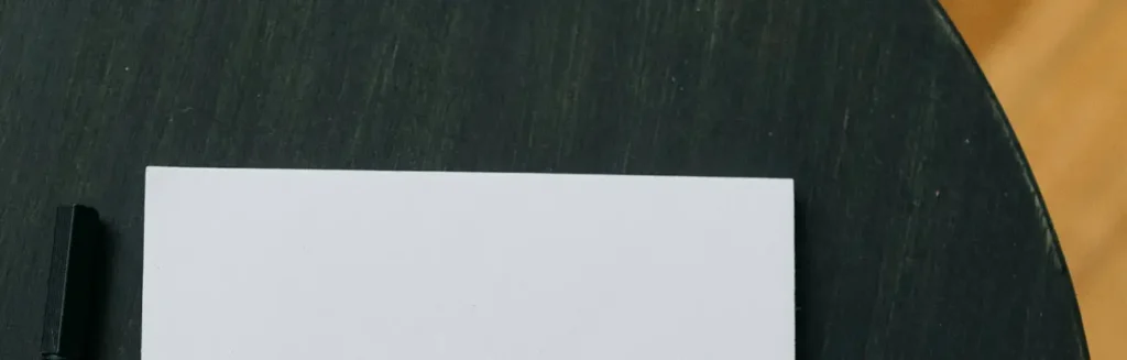 Trivera 30 years represented by a close-up of blank paper and pen on a dark wooden table