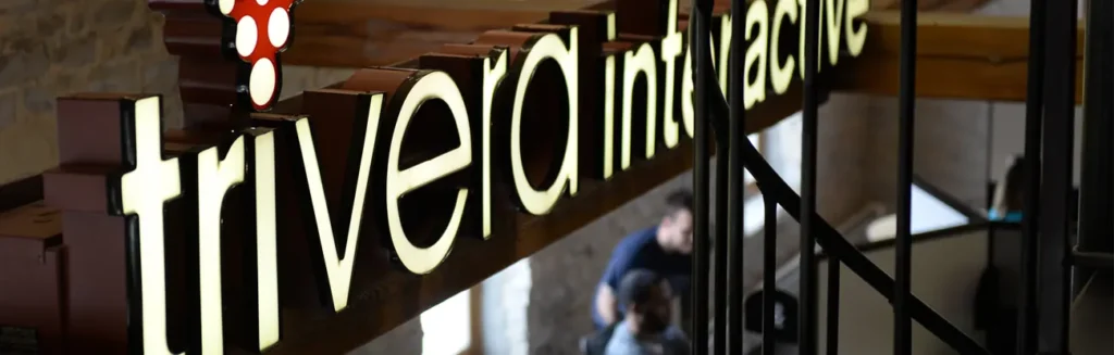 Trivera office sign with illuminated logo inside headquarters