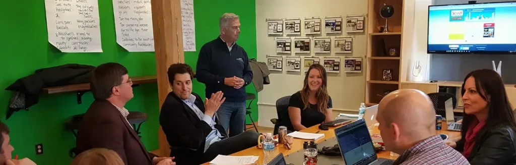 Trivera marketing team collaborating around a strategy table during a discovery session